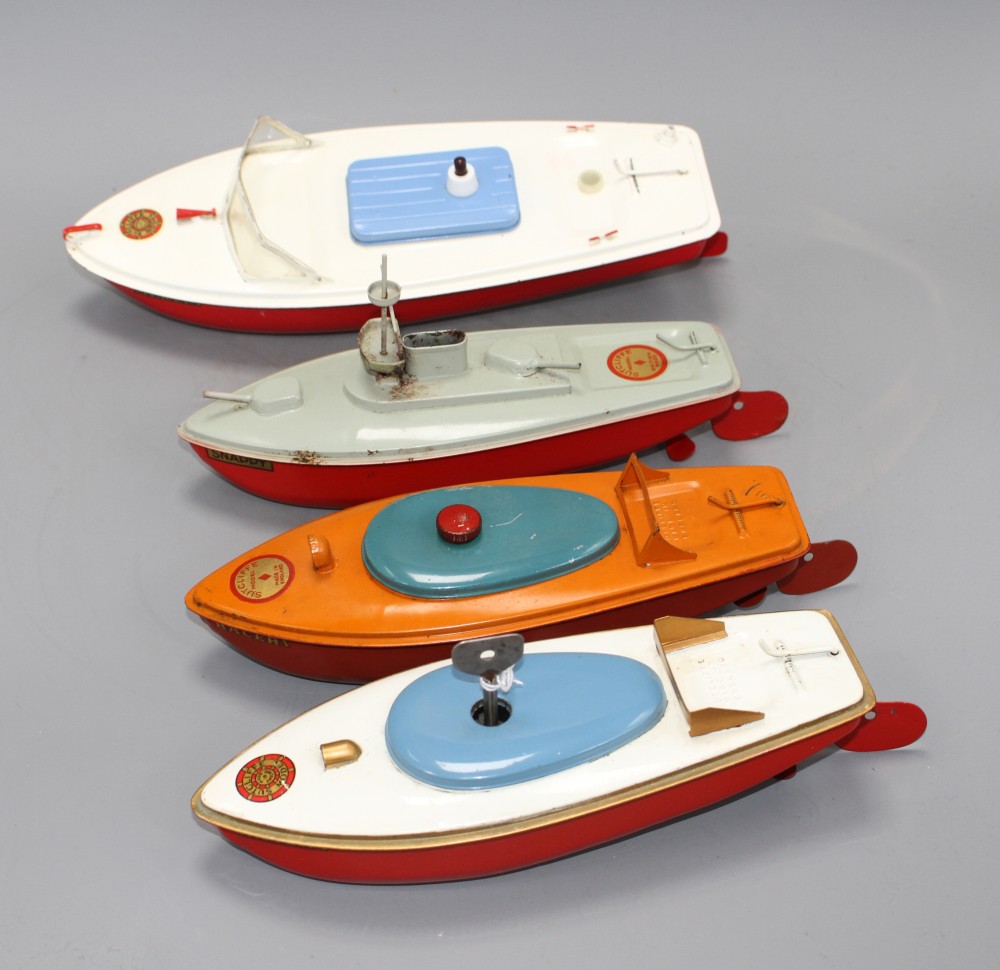 Four Sutcliffe enamelled metal model boats, comprising: two Racer I, both with clockwork, one with key, a Snappy cruiser and a Merlin